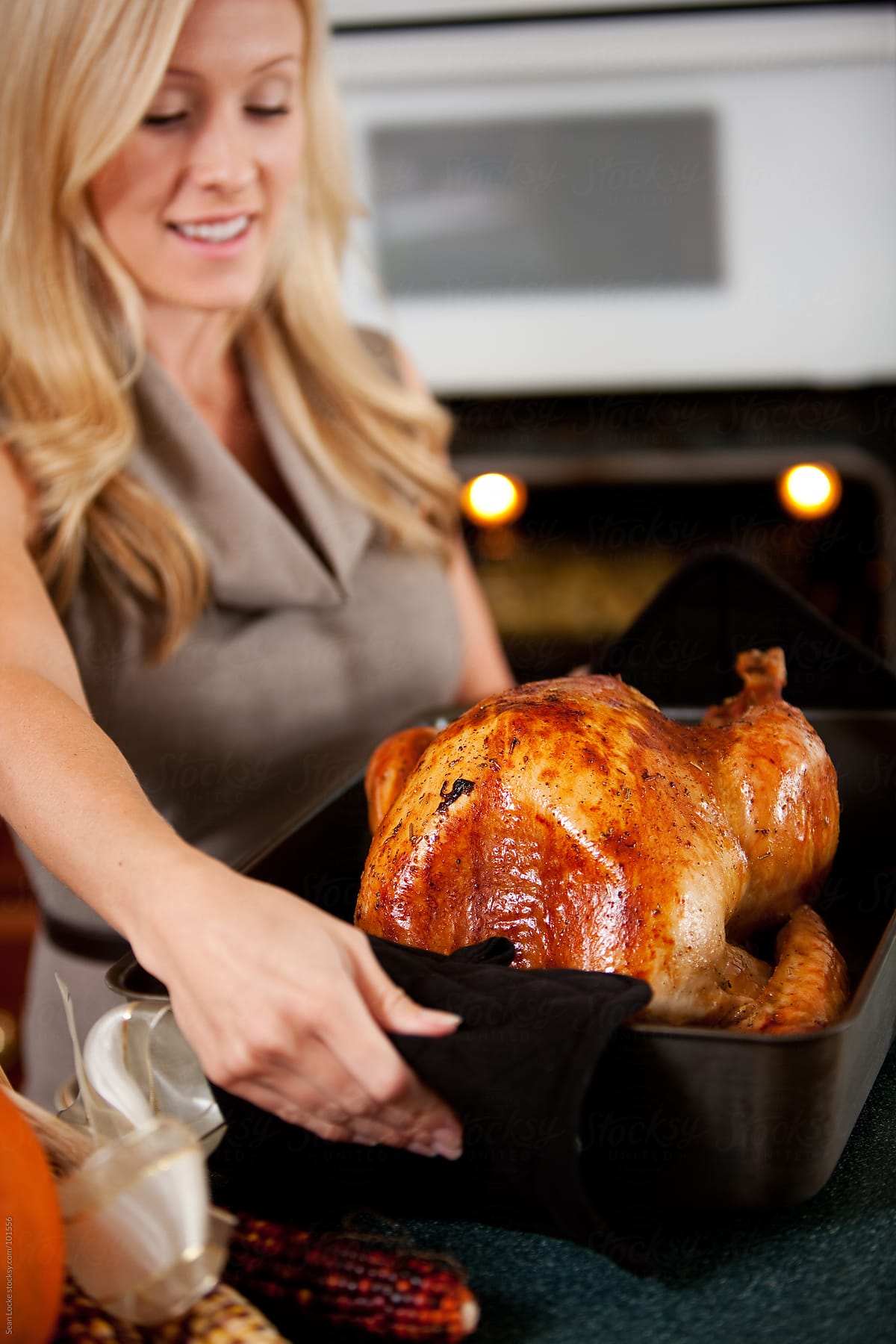 Thanksgiving: Woman Takes Finished Turkey Out of Oven