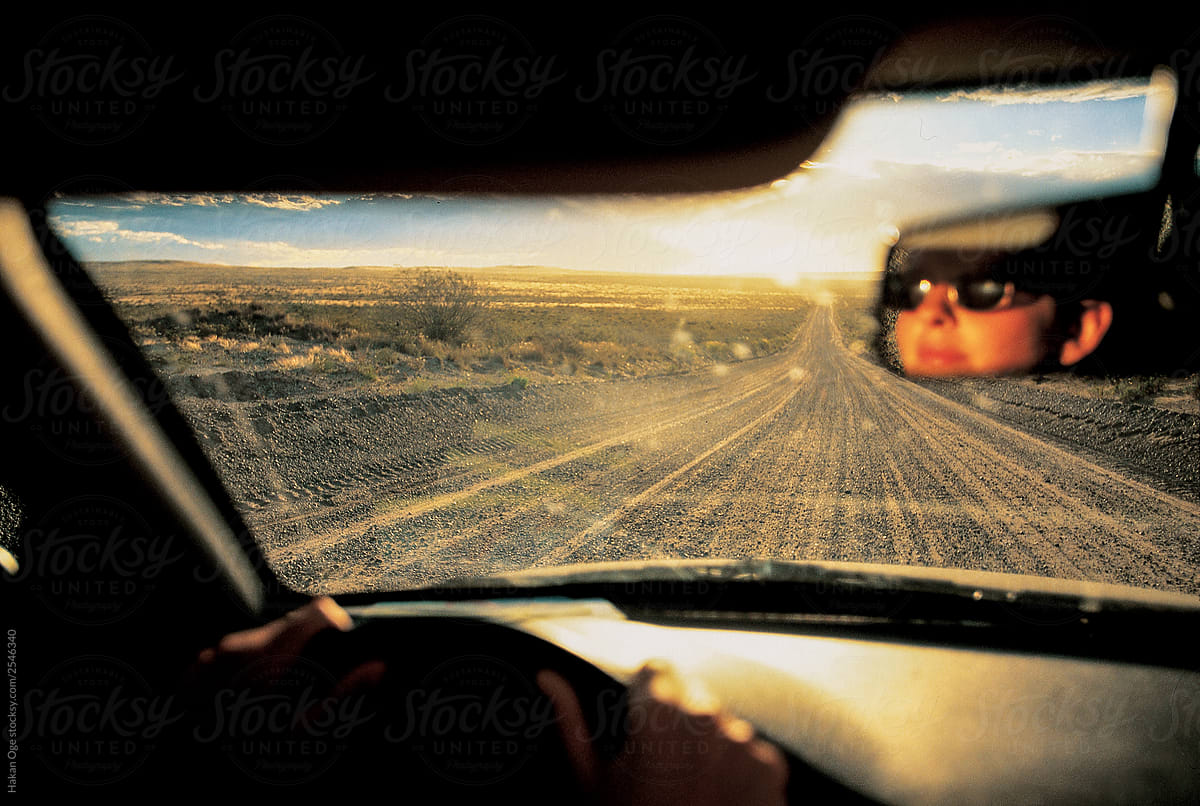 face in rearview mirror while  driving off road in Patagonia