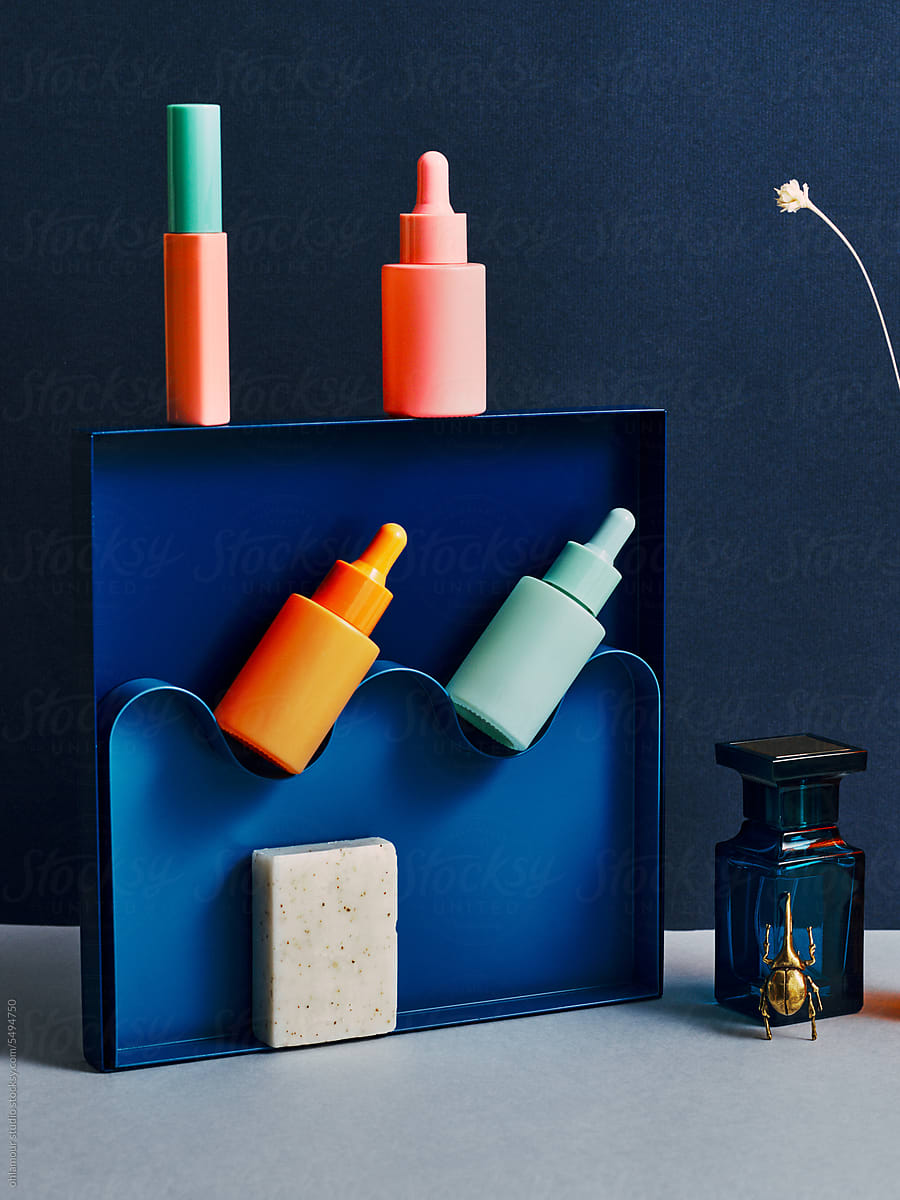 Beauty blue still life with perfum, make up and skincare products