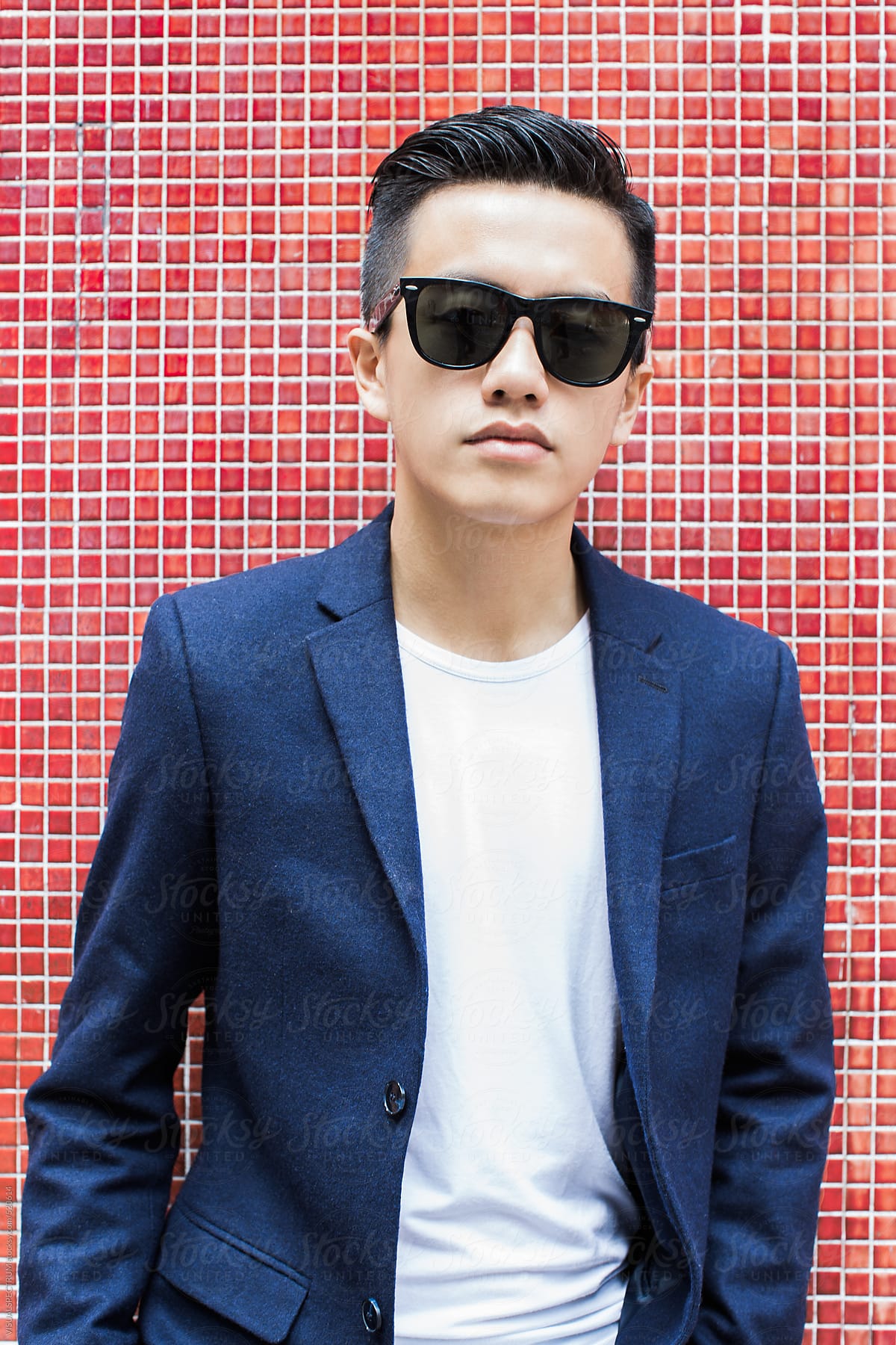 Portrait of Young Asian Man Wearing Blazer and Black Sunglasses