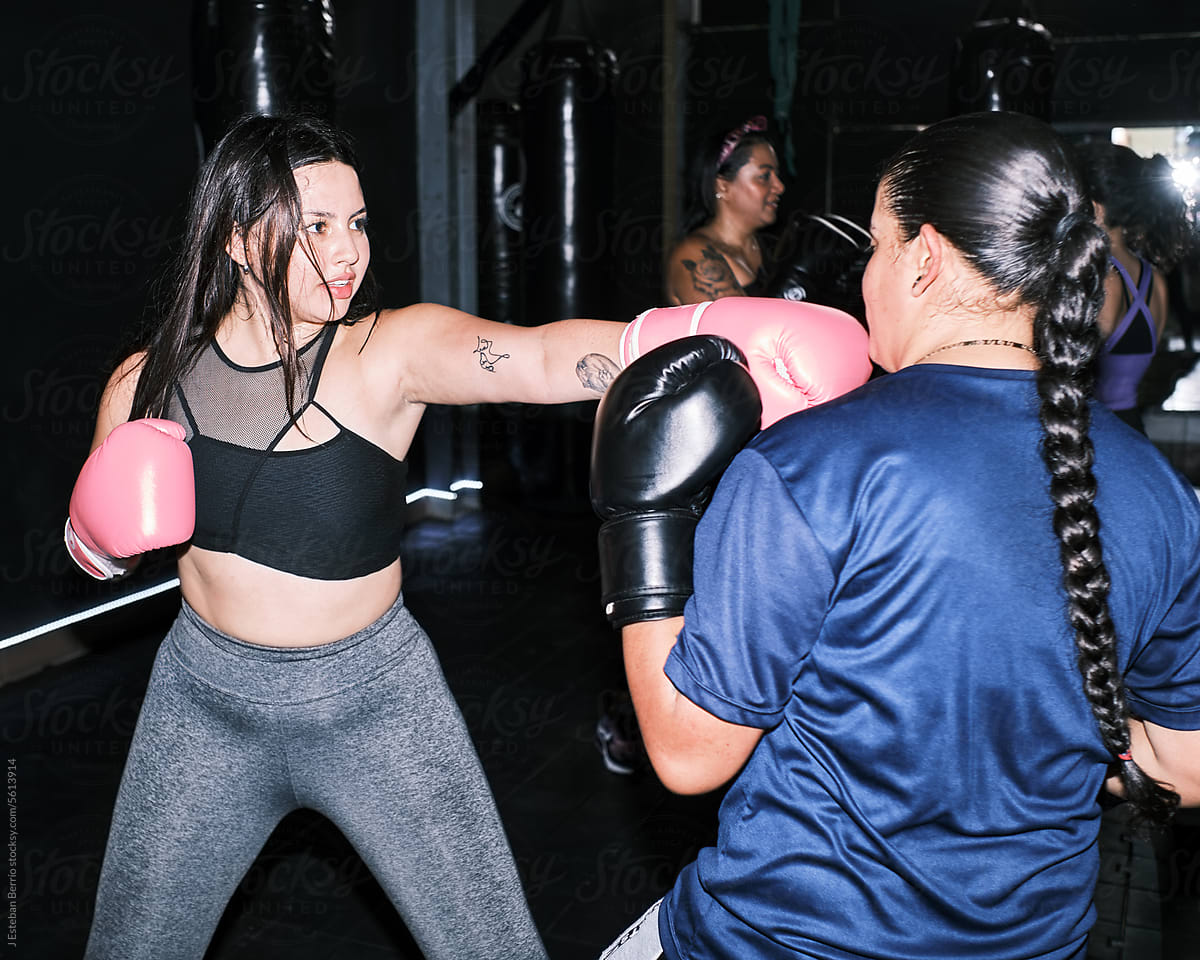 Friends practicing boxing at the gym