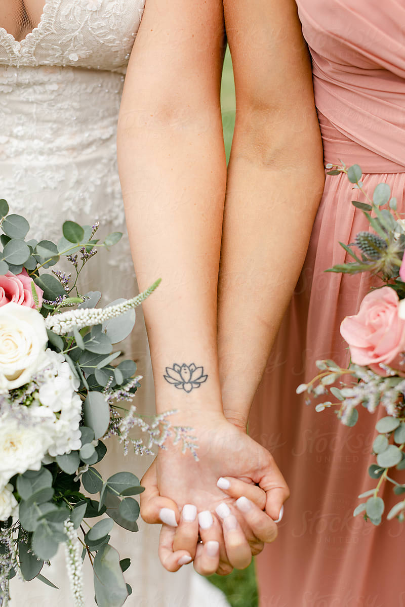 Bride and Bridesmaid Hold Hands