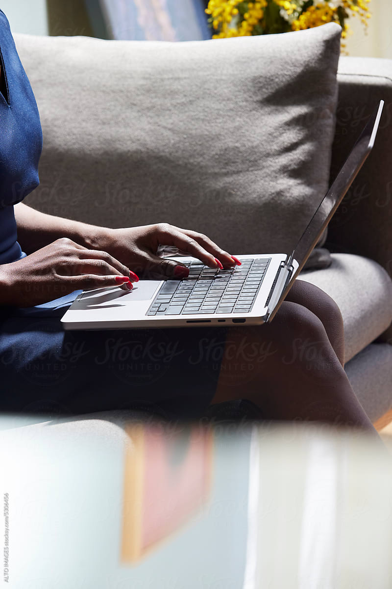 Cropped image of woman working on plan via netbook