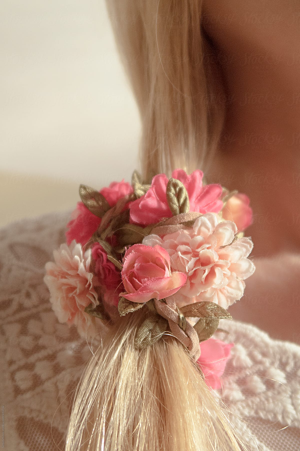flower rubber band in blond hair closeup