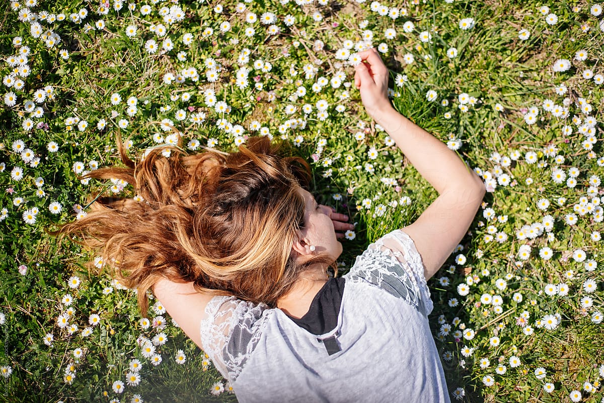 Woman Laying In The Grass By Stocksy Contributor Boris Jovanovic Stocksy