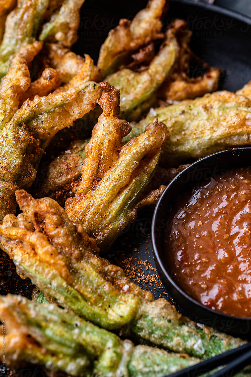 Zucchini flowers in tempura with spicy sauce and spices