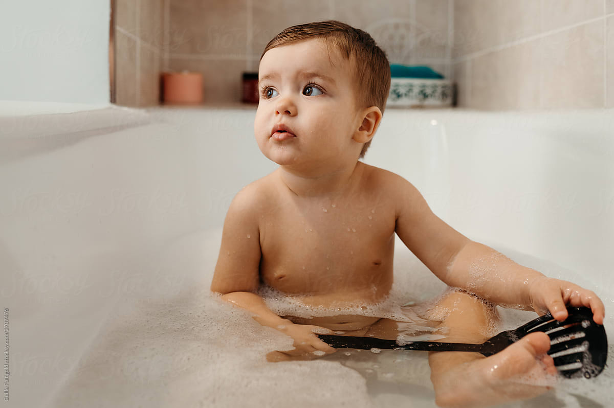 Baby sitting in bath tub