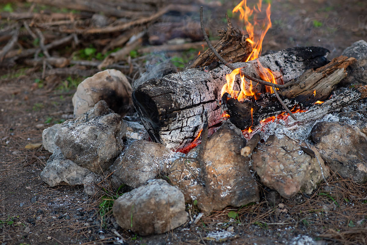 Rustic Campfire Encircled By Stones, Emitting Warmth And Light.