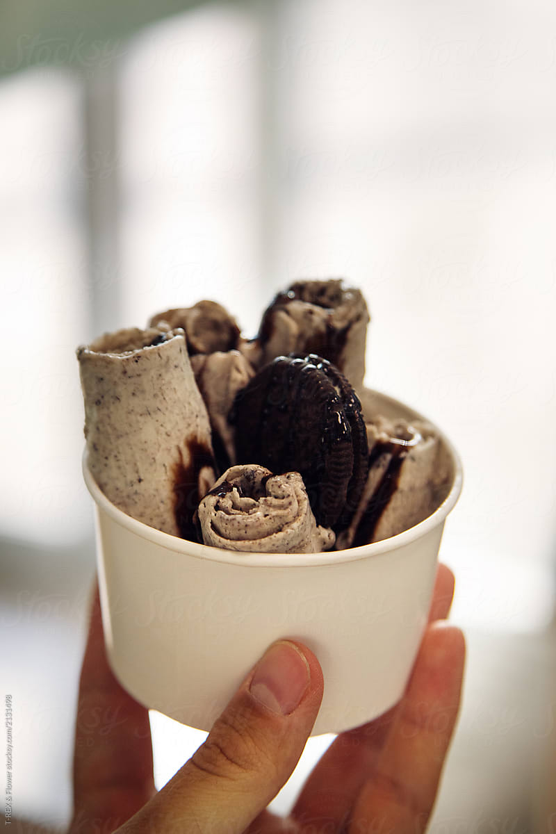 Crop hand with rolled ice cream