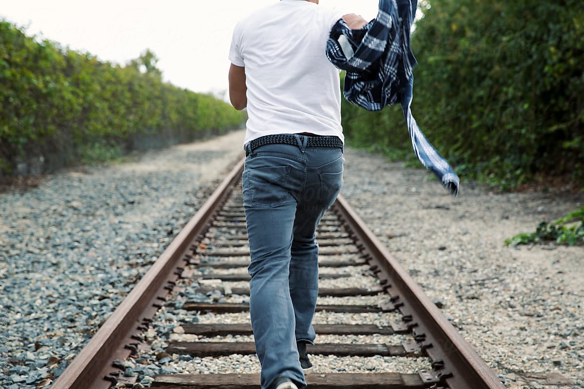 Man Running On Train Tracks by Curtis Kim.
