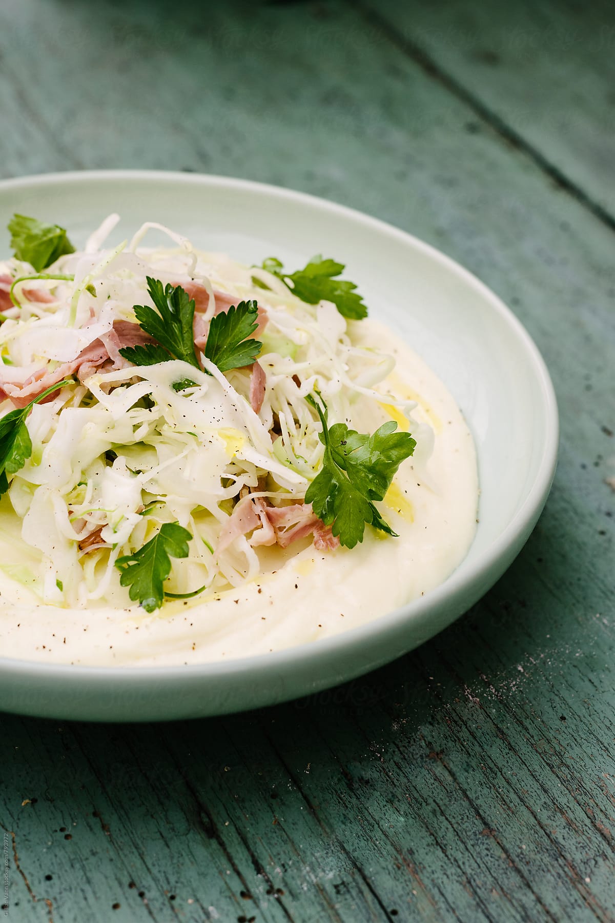 hungarian shredded cabbage with mashed potato and prosciutto