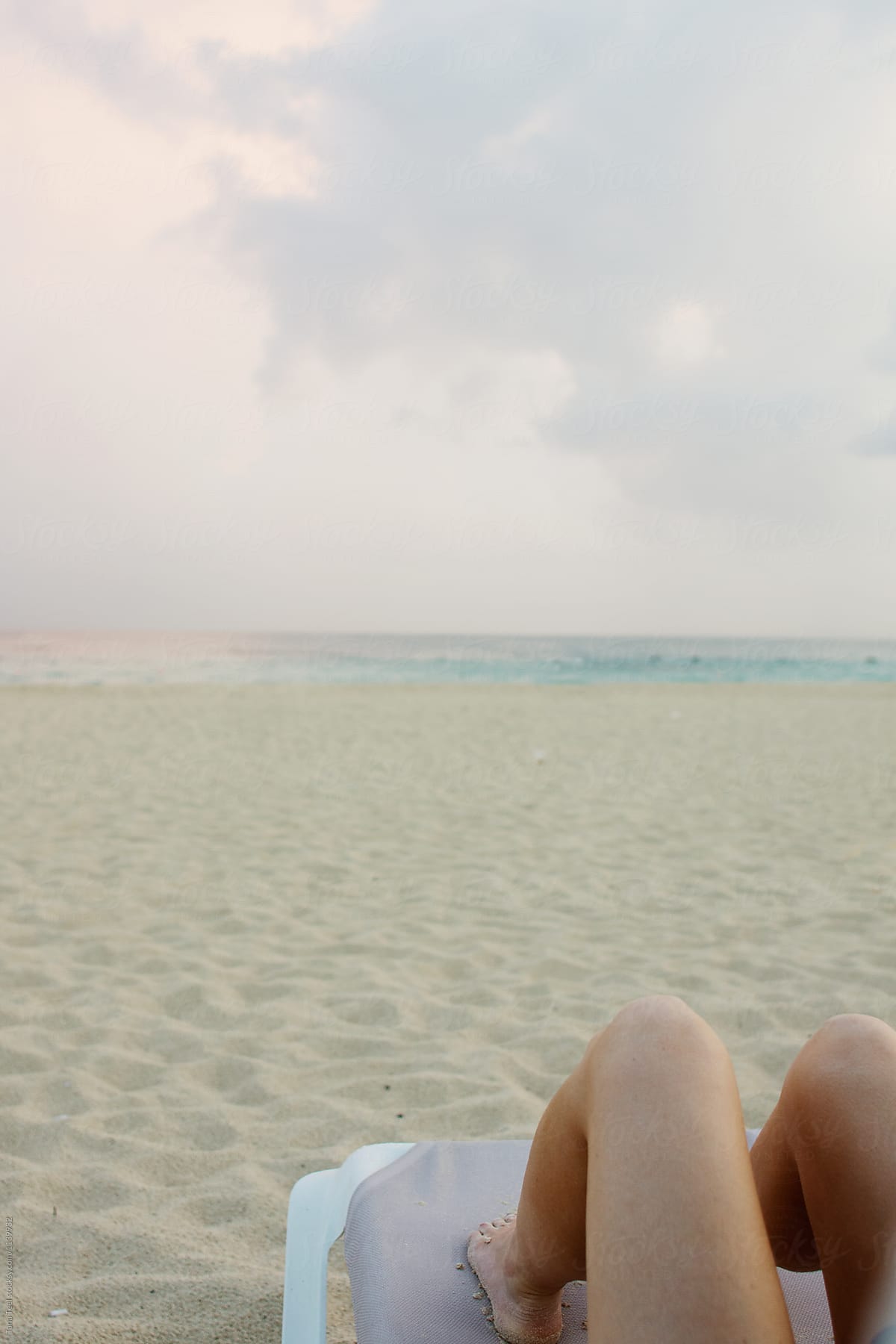 woman in lounge chair relaxing on beach