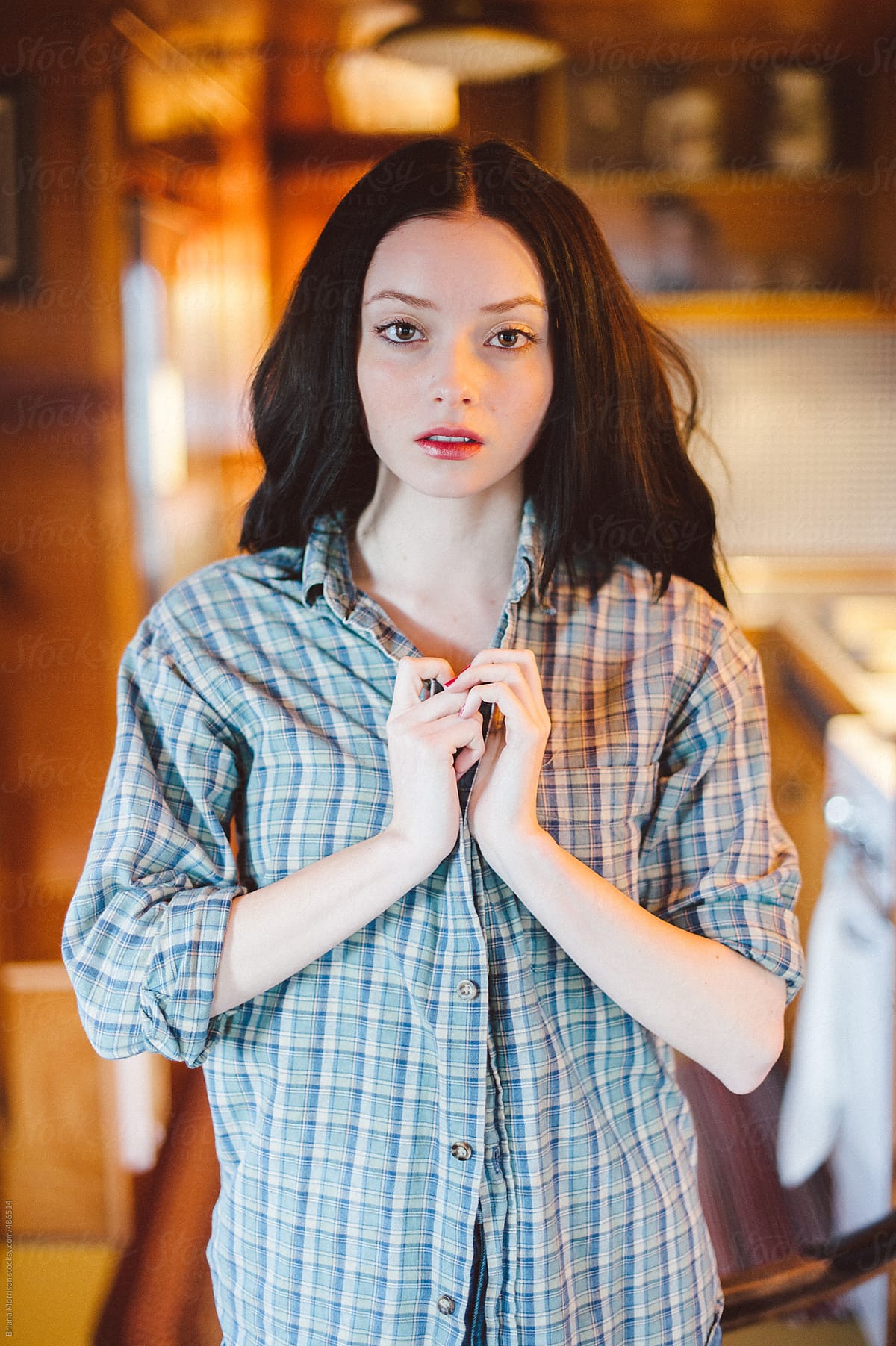 Young Woman Wearing a Plaid Shirt in a Kitchen