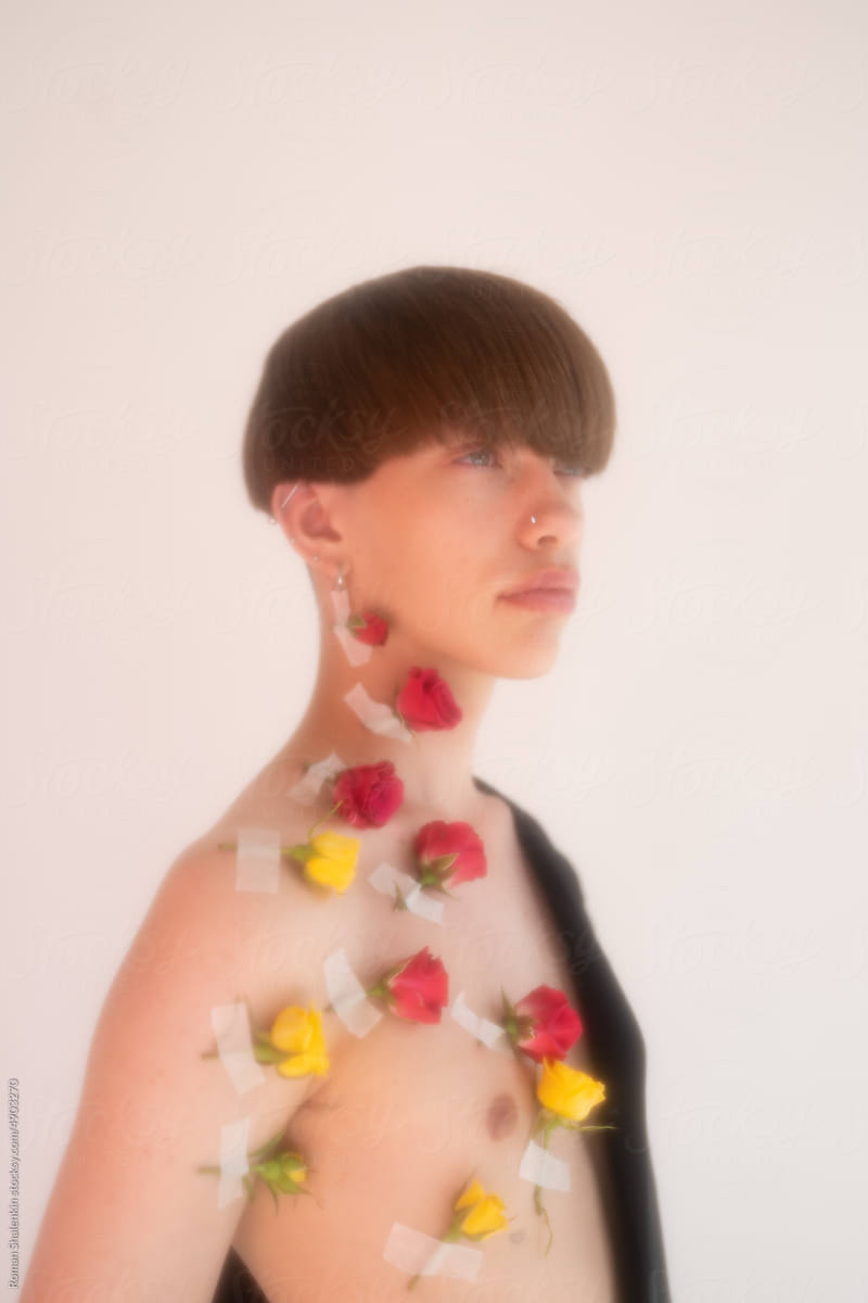 Portrait Of Young Handsome Androgynous Guy With Roses