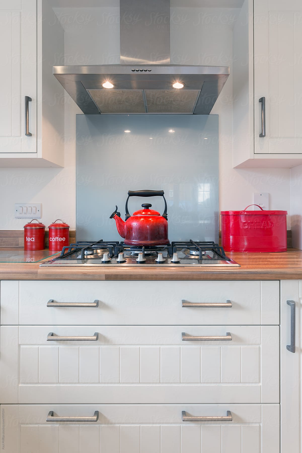 Red kettle and accessories in a contemporary kitchen.
