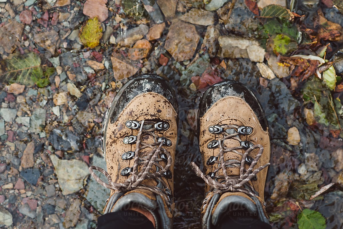 A pair of hiking boots shot from the point of view of the hiker.