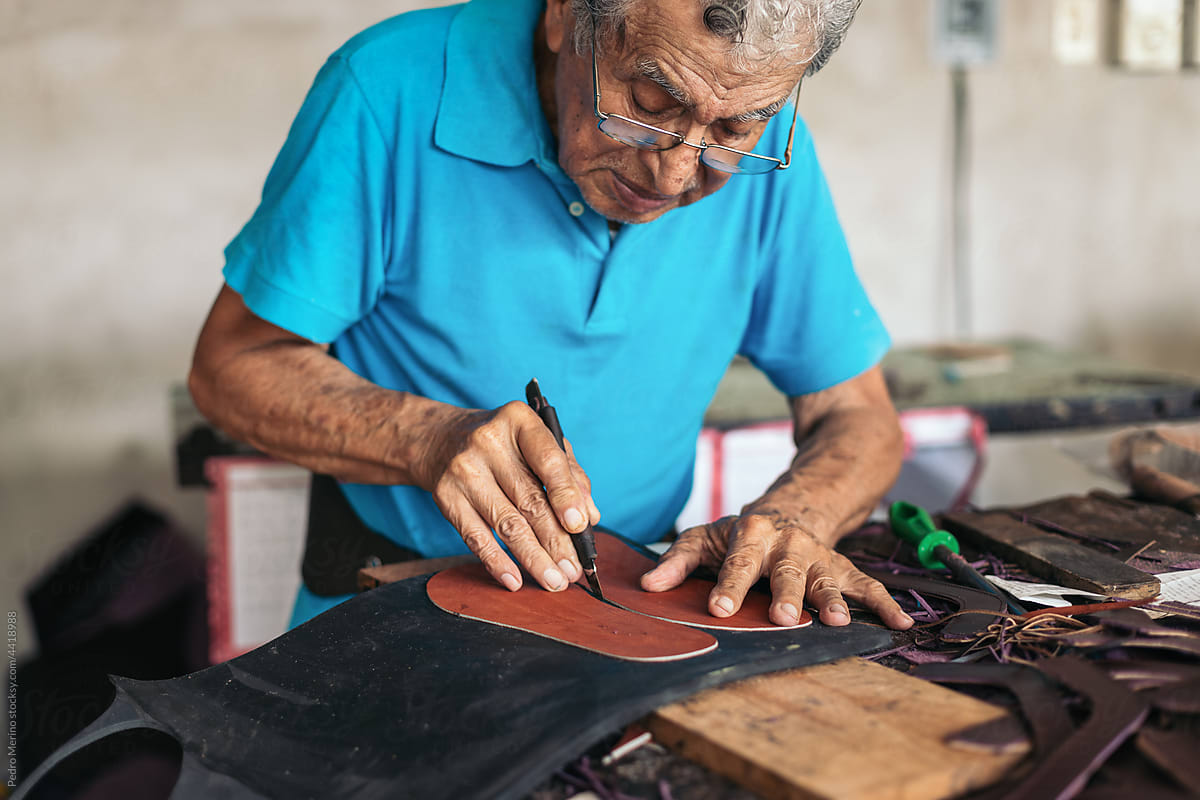 Latin senior shoemaker working