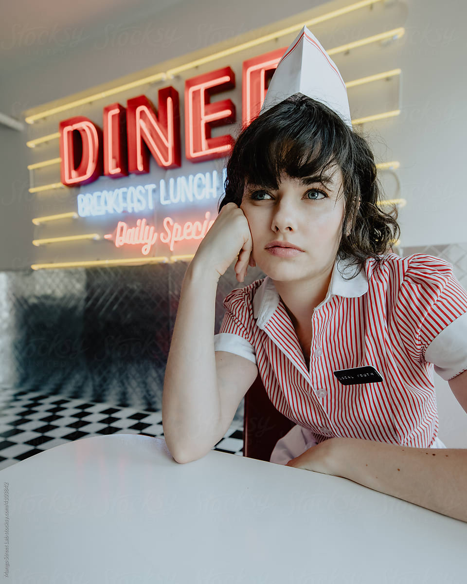 1950s Diner Waitress Sitting at Booth