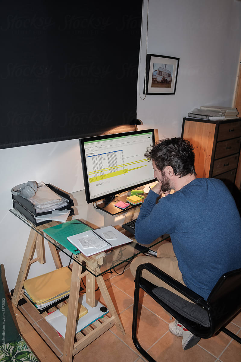 Man working on computer at home office