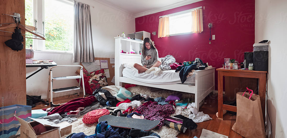 Teenage girl in messy bedroom