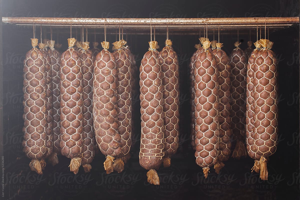 Freshly made sausage hanging in a meat smoking chamber