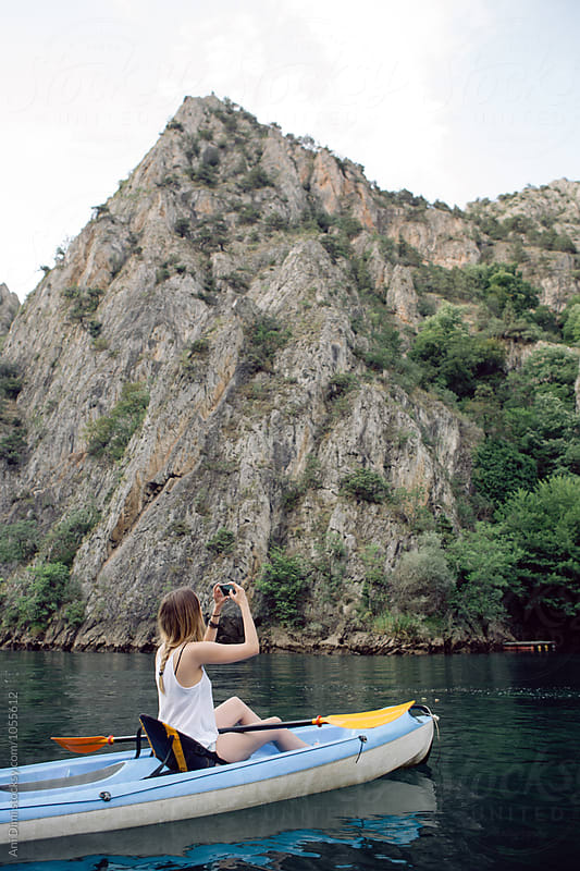 Woman kayaking and taking photos
