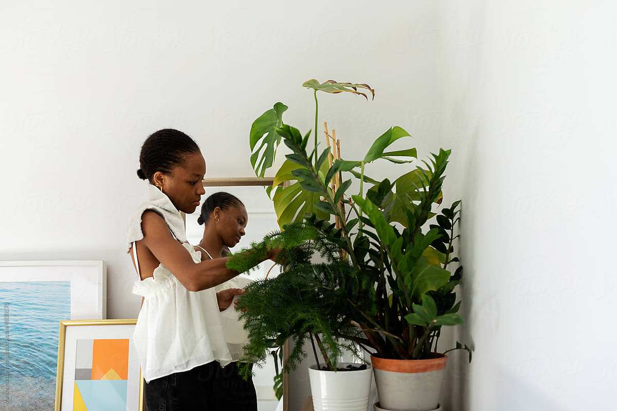 Black female taking care her plants