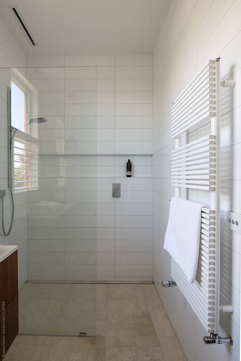White tiles shower with heated towel rail