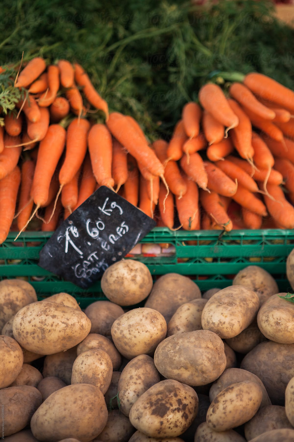 Fresh organic potatoes and carrots on market.