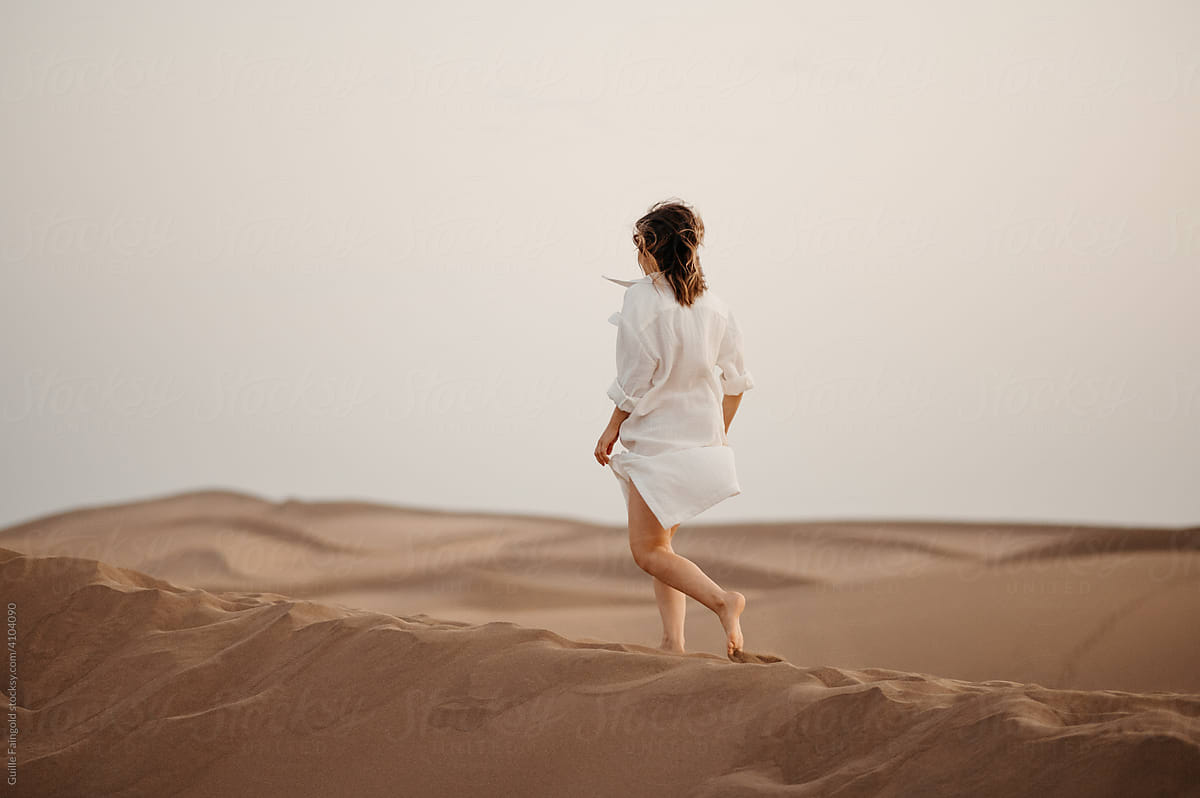 Walking woman in desert.