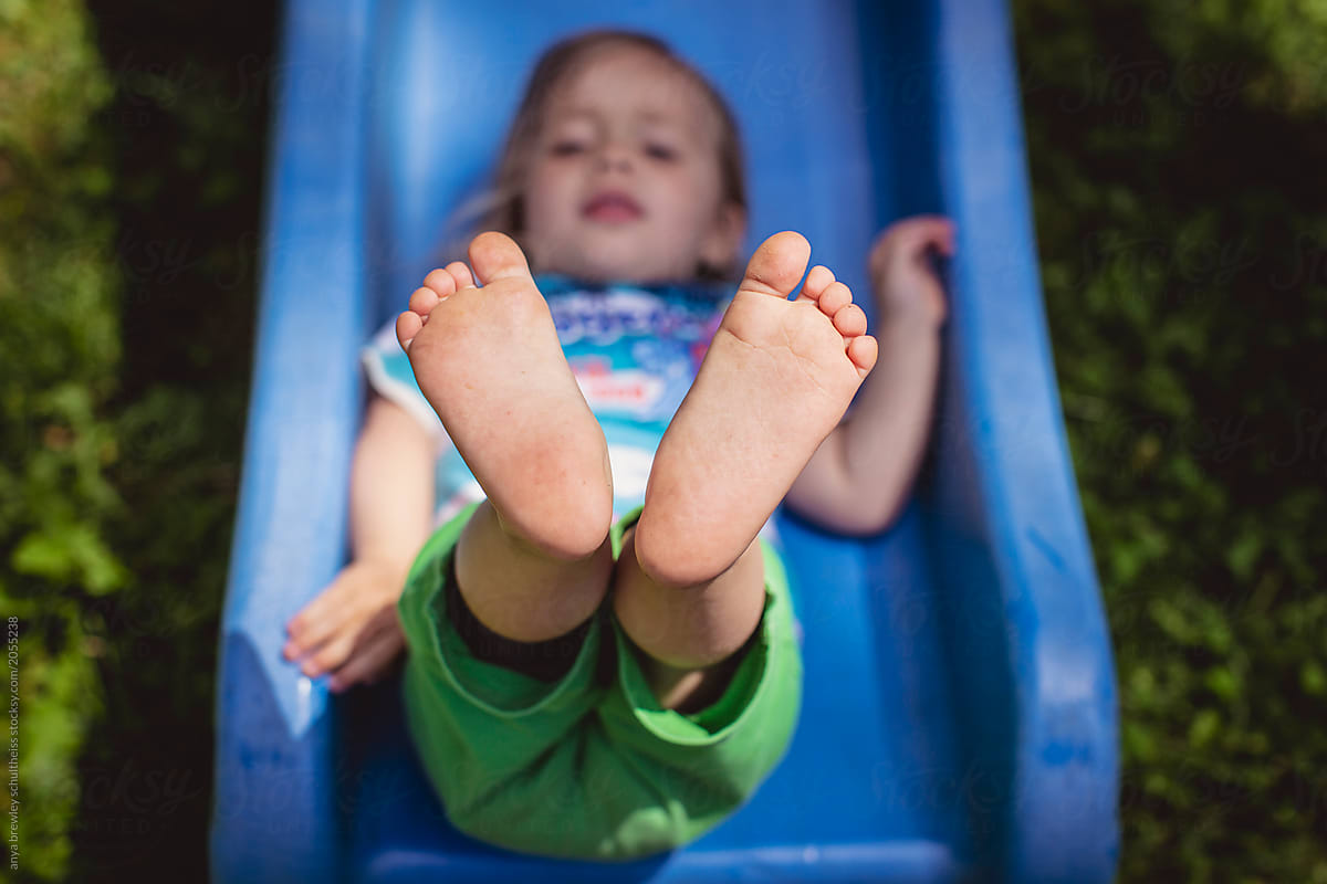 Toddler sliding down a playground slide
