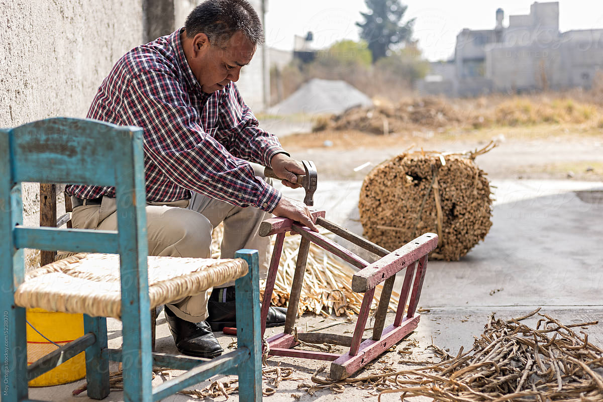 Mexican Craftsman Hammering A Chair