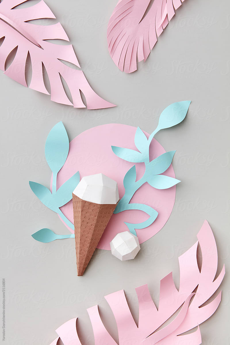 Handcraft milk ice cream in the cone with tropical leaves and fl