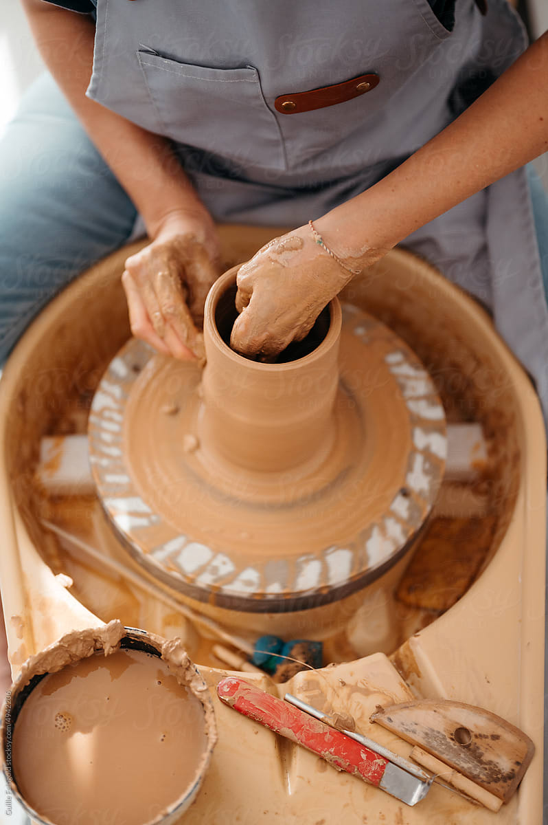 Crop artisan crafting clay vessel