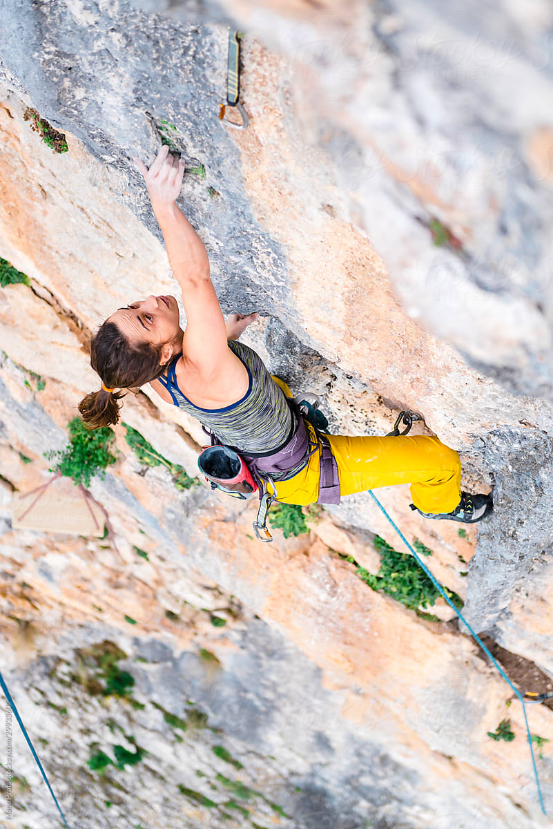 Strong woman rock climbing