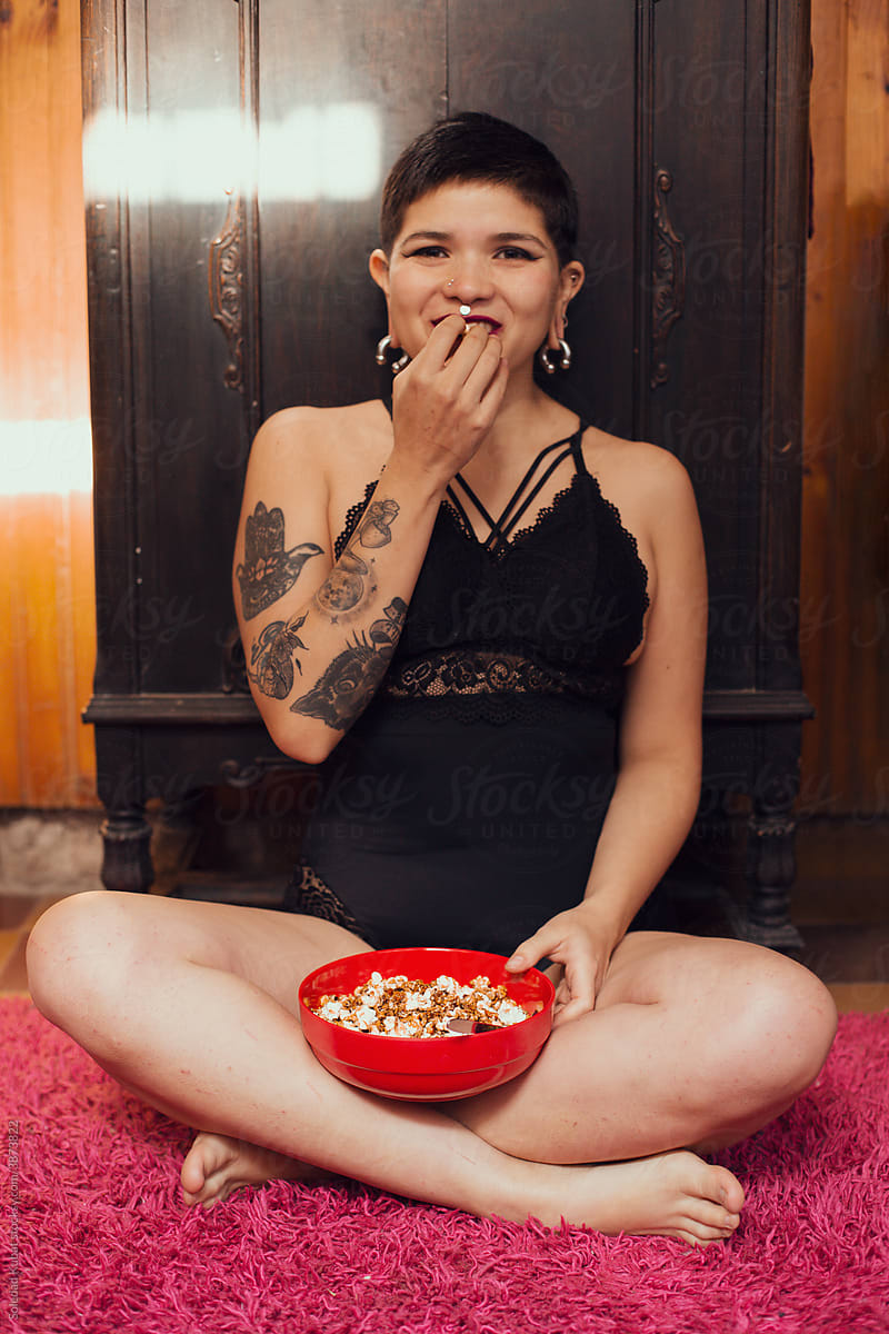 Young girl eating poporn, relaxing.