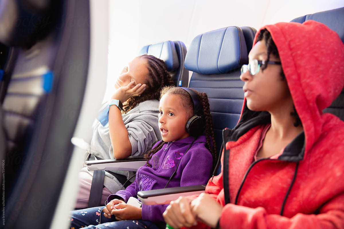 Portrait of a child with headphones watching an inflight movie