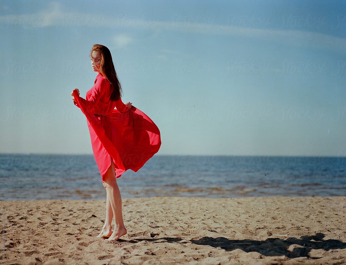 Beautiful Young Woman Standing On Seashore And Looking At Camera Del 