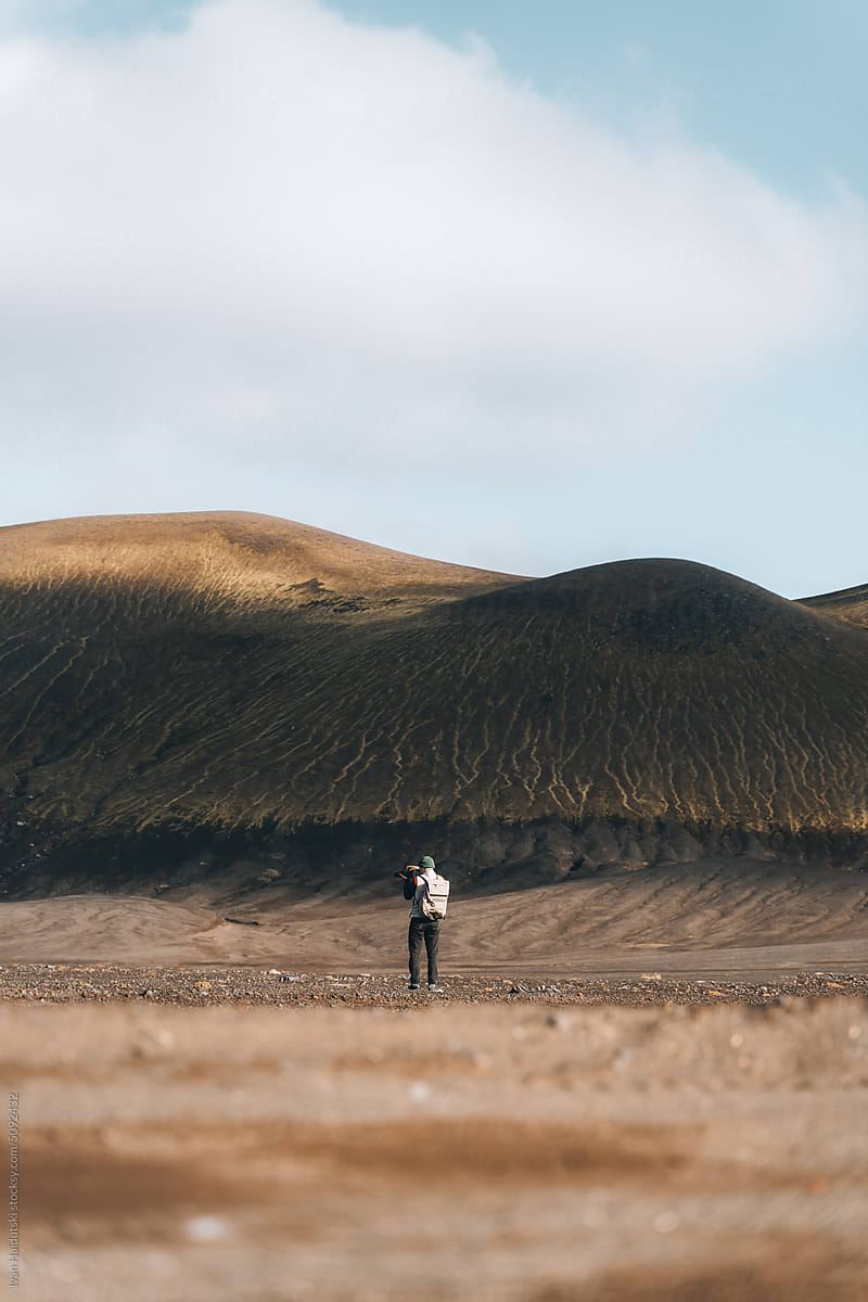 Adventurous Hiker Capturing Icelandic Volcanic Landscape