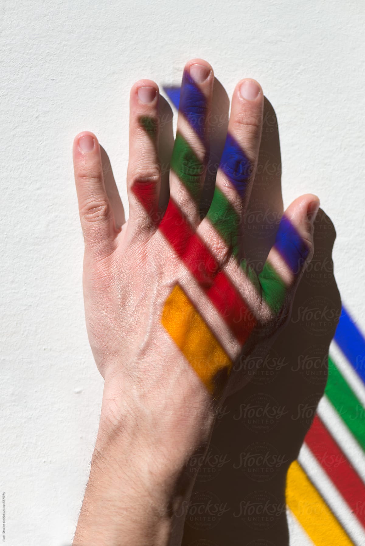 Male hand with colorful streaks of light