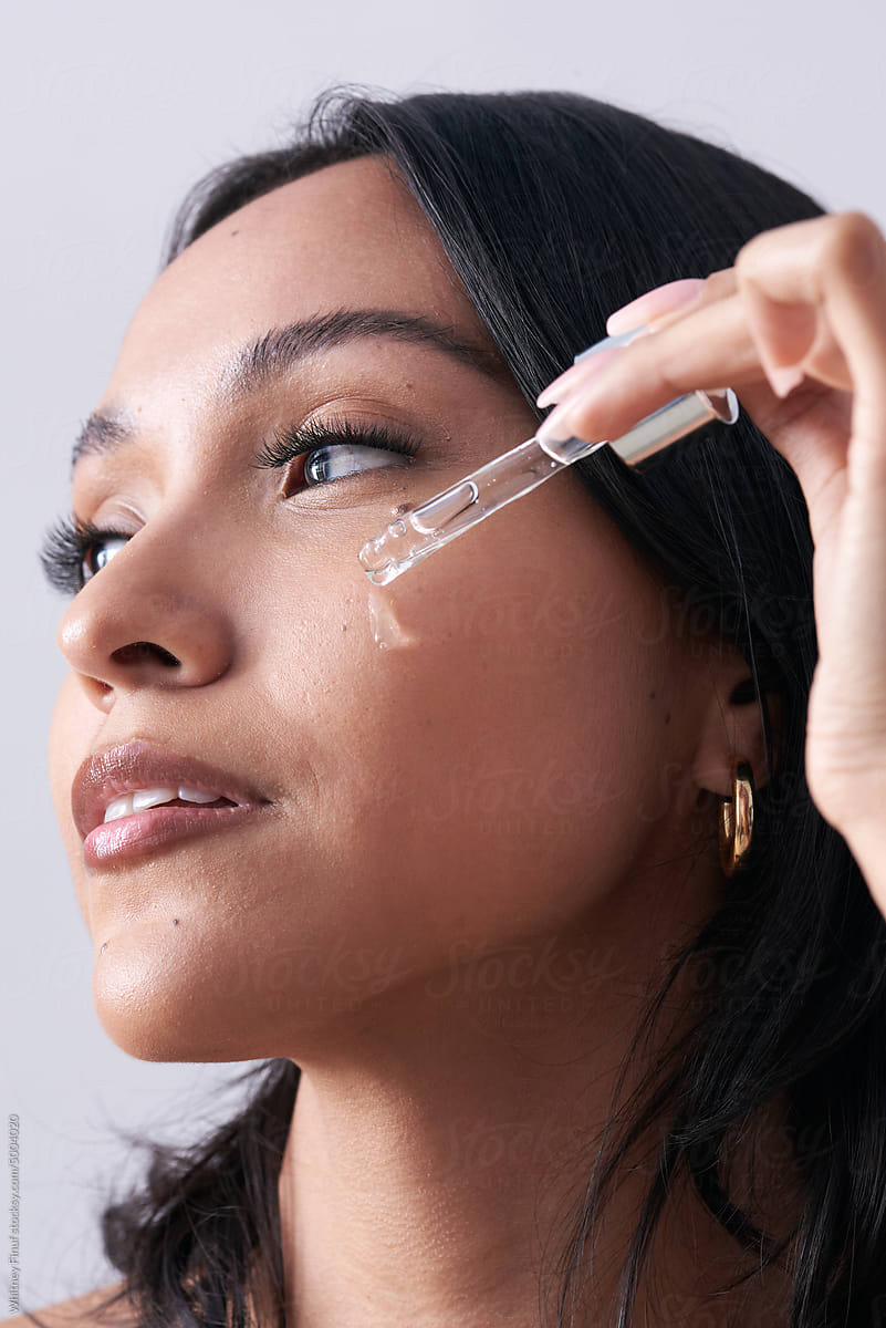 Macro Beauty Image of Woman Applying Serum to her Face