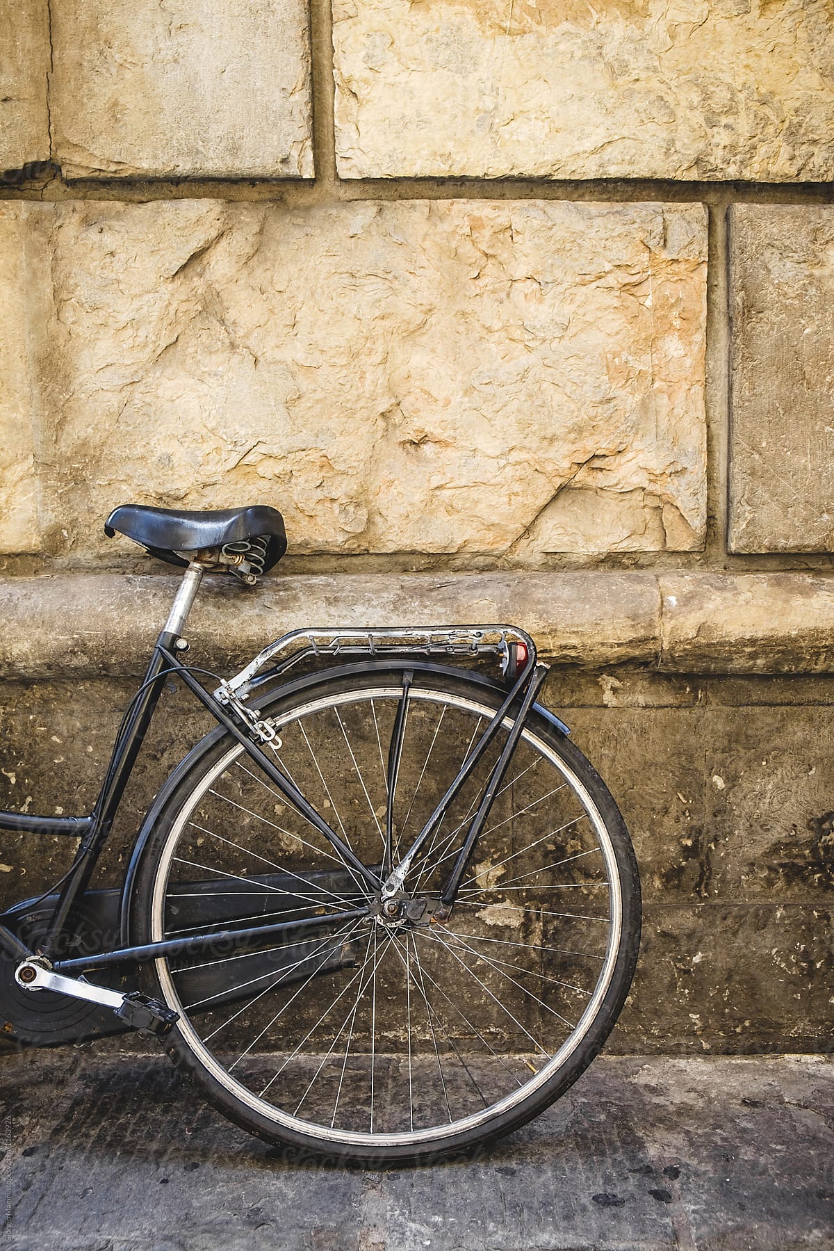 Retro Bicycle Leaning on a Grungy Wall in Italy