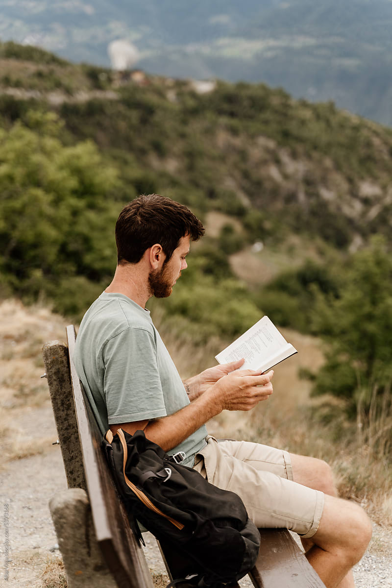 man read book in nature
