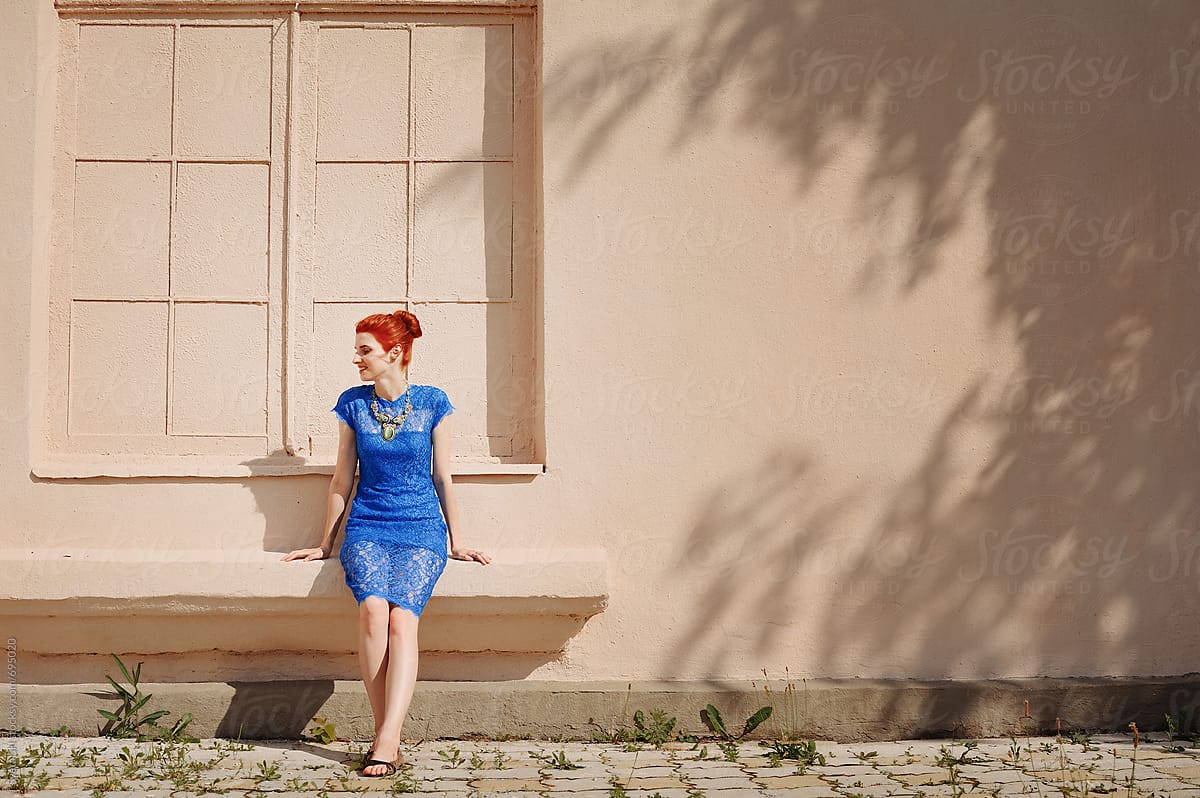Red-haired girl in a blue dress