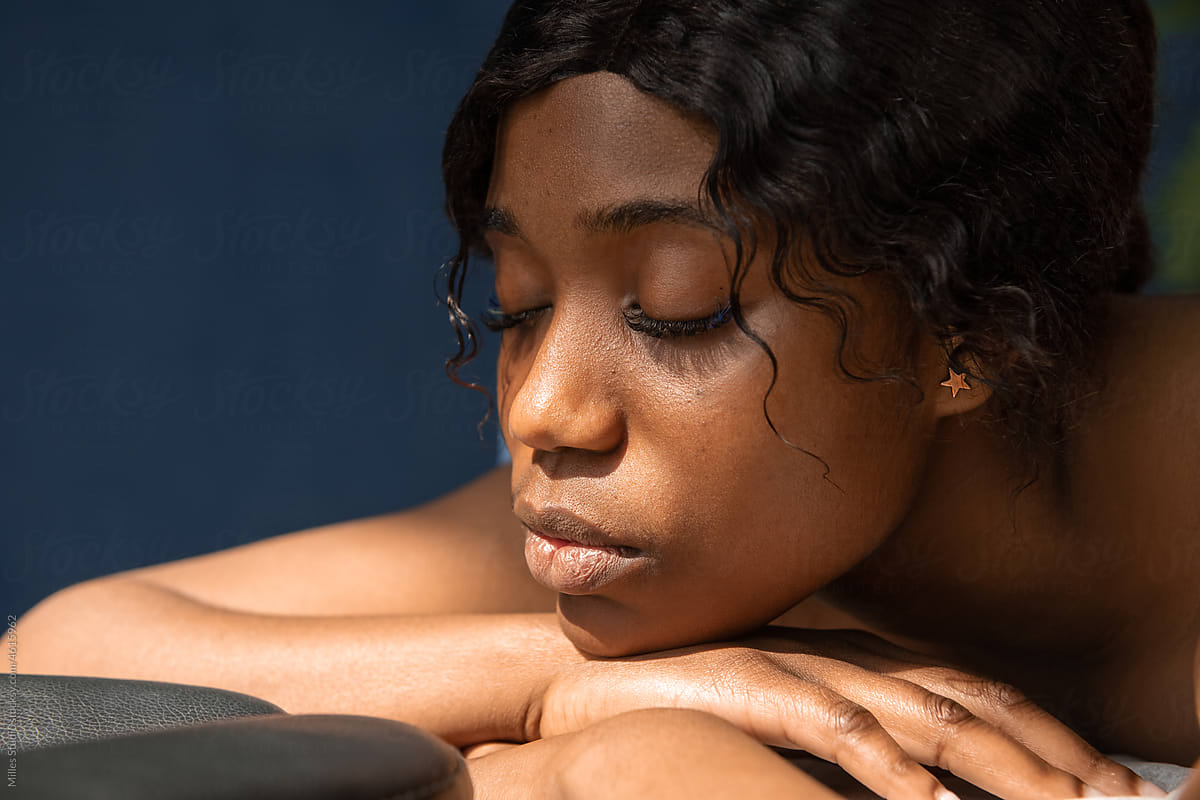 Calm black woman in massage clinic