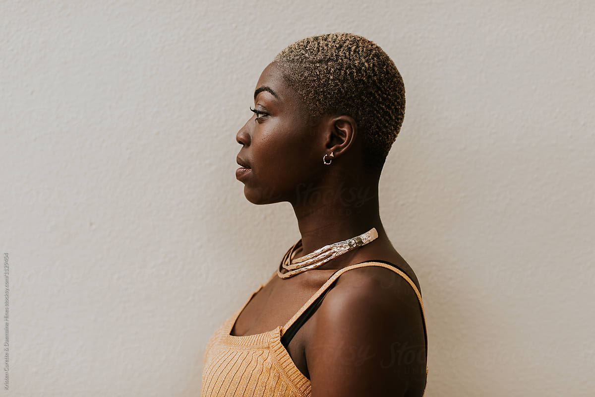 Side Profile Portrait Of A Beautiful Black Woman With A Shaved Head. by Kri...