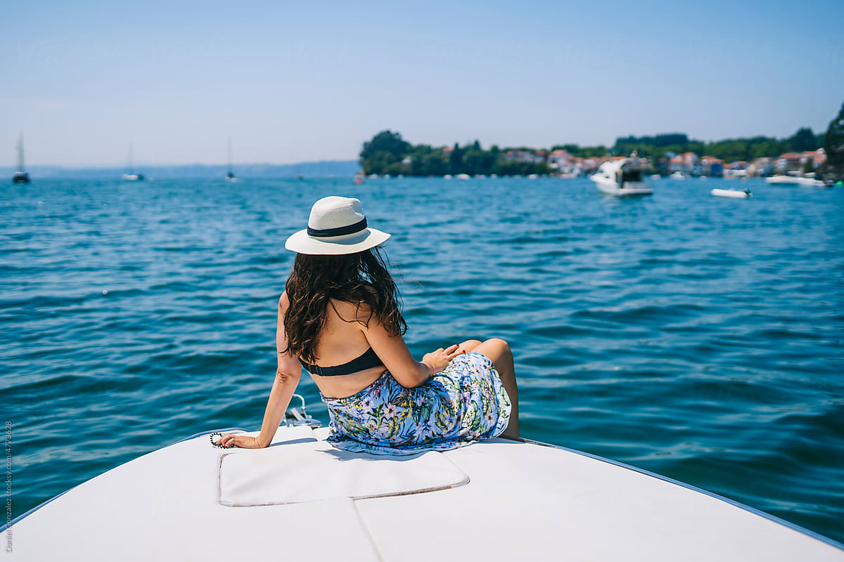 Anonymous lady relaxing on yacht on summer day