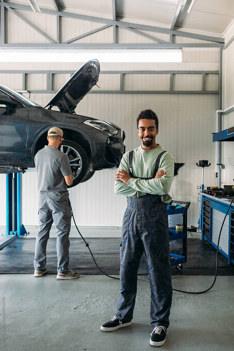 Two Mechanics Repairing Car in Garage