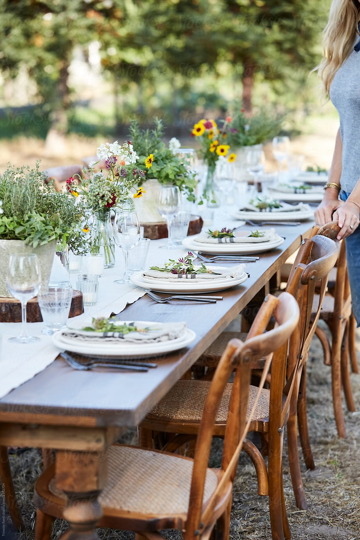 Woman setting the table for a farm to table dinner party