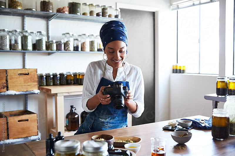 Millennial African American Woman Maker taking a photo of her products